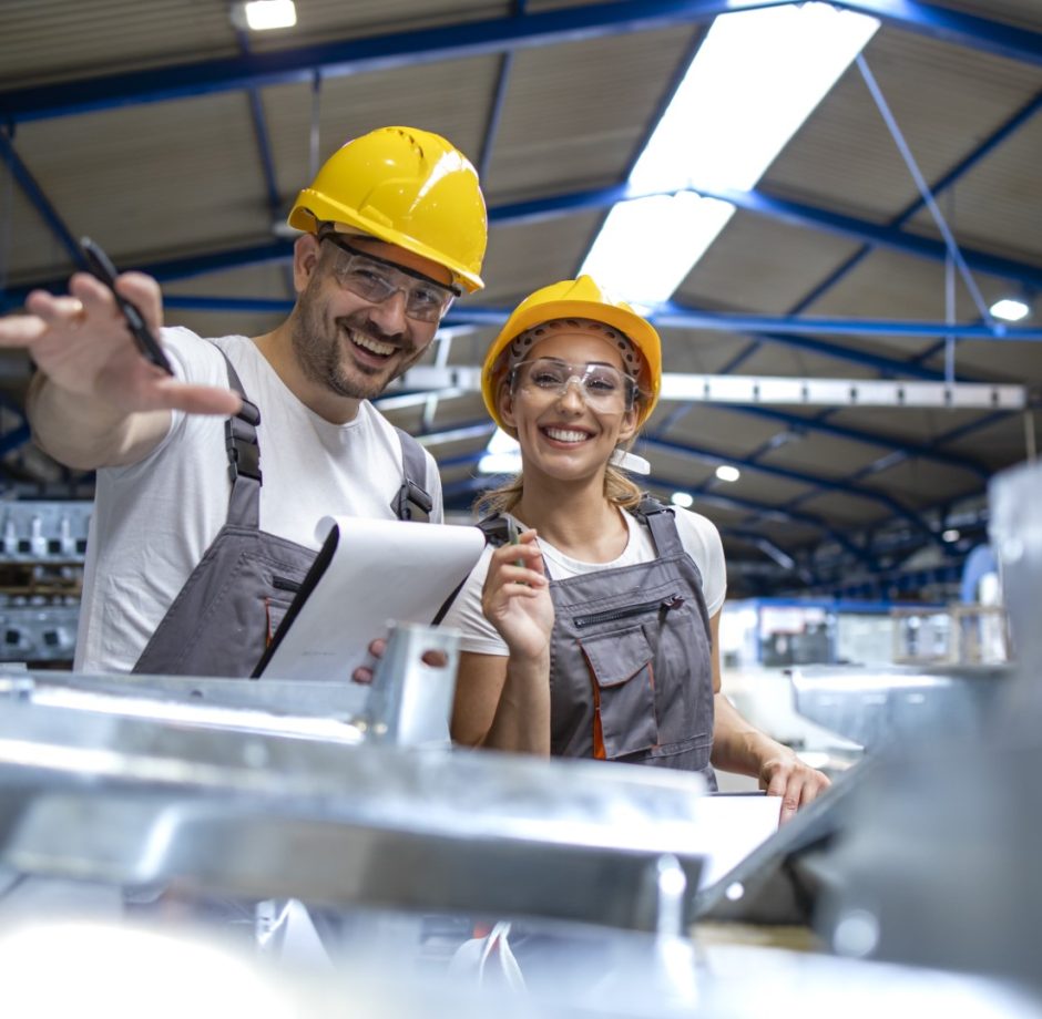 Factory workers controlling quality of manufactured products together. Factory workers controlling quality of manufactured products together.